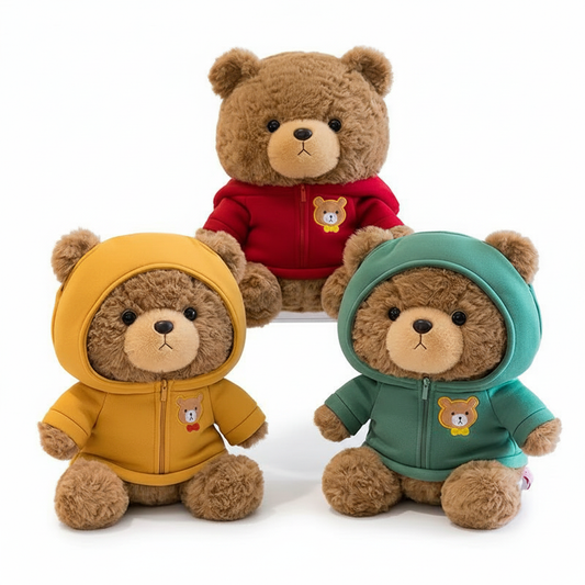 Three teddy bears wearing colorful hoodies on a white background