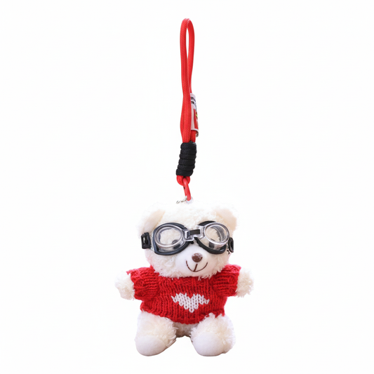 Plush toy bear with goggles and red sweater on a white background